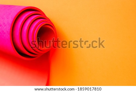 bright pink ultramarine yoga mat on a orange background