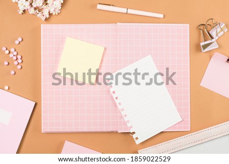 flat lay pink stationery on work desk in brown pastel background