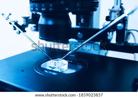 Microscope of reproductive medicine clinic fertilizing egg outside female body Royalty-Free Stock Photo #1859023837