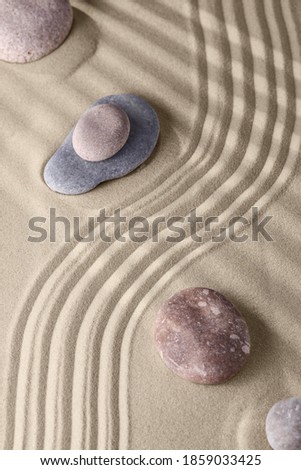 Smooth lines on the sand and round stones in the rock garden, for relaxation and spiritual harmony. Zen garden of meditation, relaxation, restoration of balance and harmony of spirituality, relaxation