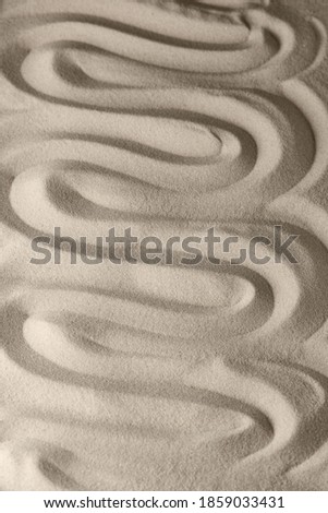 Sand surface texture with smooth lines and shadows, for relaxation and spiritual harmony. Garden of meditation, relaxation, restoration of balance, harmony of spirituality and relaxation