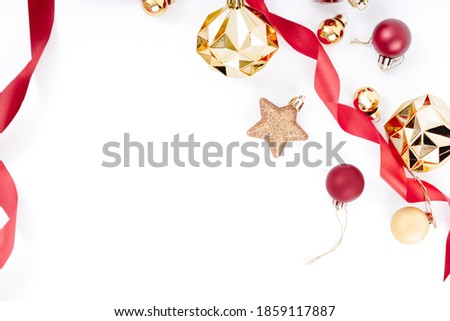 Top view of Christmas elements, ball, ribbon, stars glitter, gold and red ball, bells on white background.