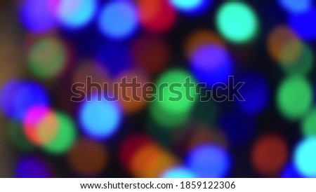 Christmas decoration. Hanging red balls on pine branches christmas tree garland and ornaments over abstract bokeh background.blurry perspective view.