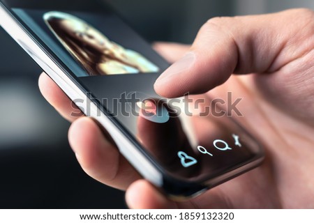 Online dating app in mobile phone. Like or swipe to match. Single man looking for love and relationship with smartphone. Woman with beautiful profile picture on internet site. Date and romance website