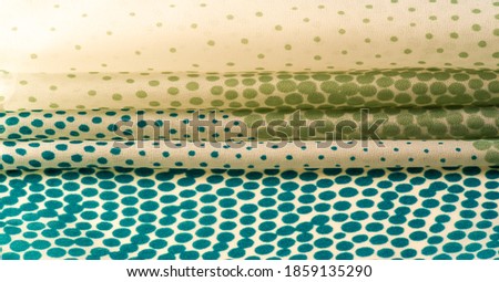 silk fabric. texture or background with cool mint, blue and yellow green polka dot dots on a beige backdrop for web design, desktop wallpaper, winter blog, website or invitation card.
