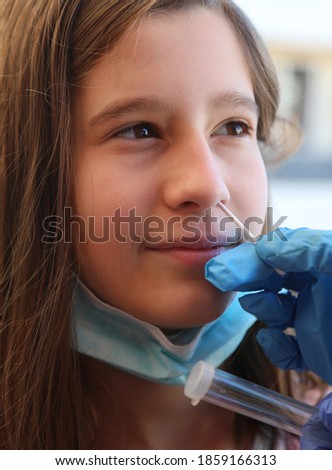 little girls doing a nasopharyngeal swab for coronavirus research with hand of doctor Royalty-Free Stock Photo #1859166313