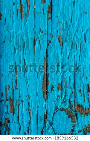Wooden surface painted with blue paint, abstract background of a bench, fence or door