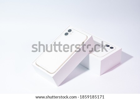 White smartphone with two cameras on a white background