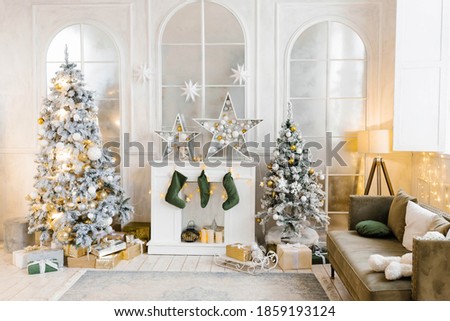 Bright cozy living room with a large elegant Christmas tree, decorated for Christmas Royalty-Free Stock Photo #1859193124