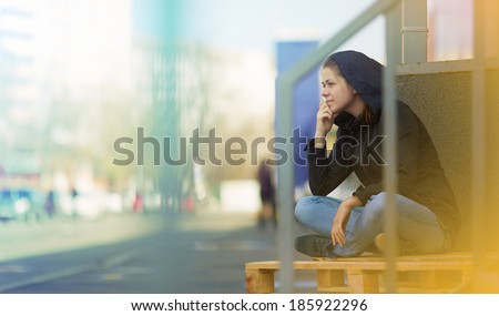 Woman sitting in city. Street photo. Outdoor.
