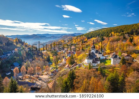 The Spania Dolina village with church and historic buildings in valley of autumn  landscape, Slovakia, Europe. Royalty-Free Stock Photo #1859226100
