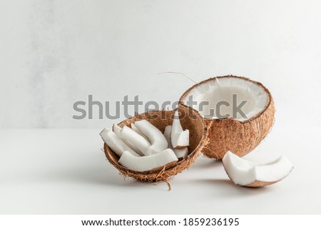 fresh coconut and coconut slices on a light background. place to copy. healthy diet