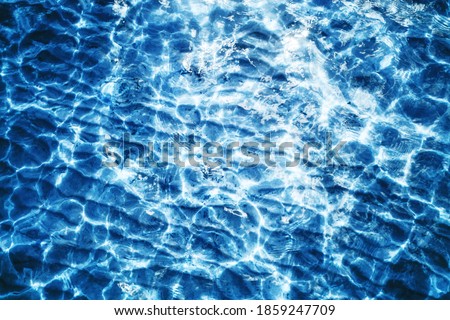 Sea wave background. Calm waves on shallow water. Ripples on lake water. Blue lake surface texture. Outdoor summe ocean perspective backdrop.