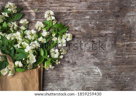 Flowers composition for Valentine's, Mother's or Women's Day. Jasmine Spring Flowers On old wooden Background