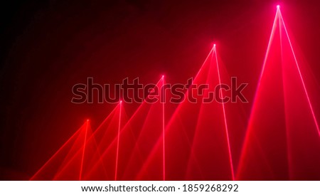 Interactive exposition in science museum or exhibition: bright laser show installation with red color rays or beams in dark room. Performance, technology, visuals, digital, contemporary art concept Royalty-Free Stock Photo #1859268292