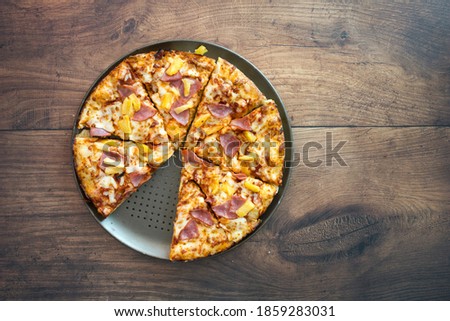 Hawaiian Pizza Shot from above on a Wooden Table