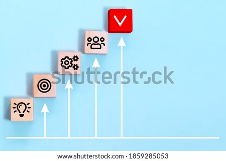 Business process management, plan a project with wooden cubes with icon business strategy on blue background. Royalty-Free Stock Photo #1859285053
