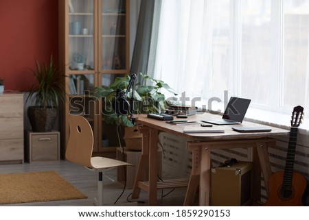 Background image of inviting home recording studio with music equipment and guitar, copy space