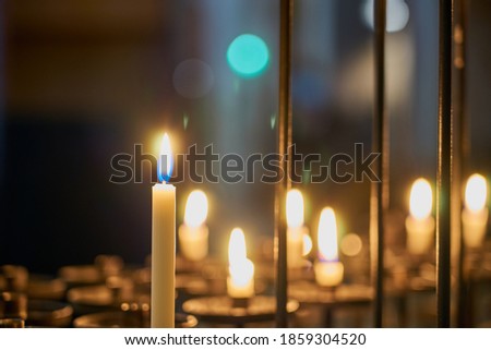 Candles in the church at close range with a blurred background.
