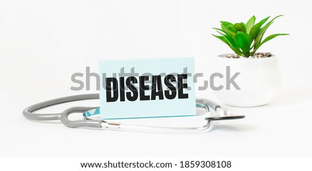 DISEASE word on notebook,stethoscope and green plant