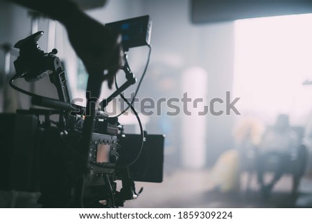 Professional film and video camera on the set. Shooting shift, equipment and group. Modern photography technique. Royalty-Free Stock Photo #1859309224