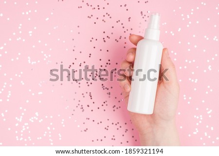 Closeup photo picture of female girl woman hand holding showing plastic container with empty place for label design on stylish fashionable shiny background