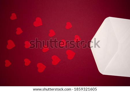 Envelope with hearts on red background. Romance and love concept. Vertical