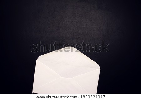Open envelope on the black background. Information and business concept