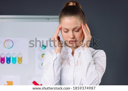 A young boss has a headache during a conference. Virus and pandemic concept. Royalty-Free Stock Photo #1859374987