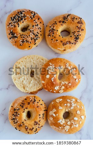 Flat lay of bagel breakfast on light table, top view