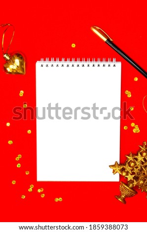 gold shiny christmas toys and golden decorations festive confetti , greeting card, mock up, copy space, white sheet of paper, xmas theme