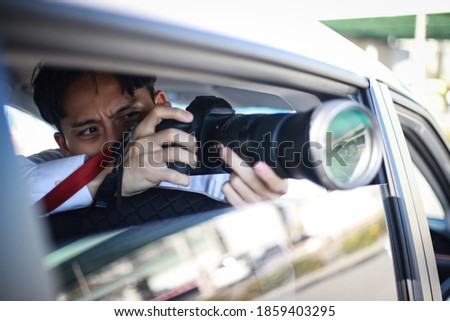 A man taking a picture from inside the car Royalty-Free Stock Photo #1859403295