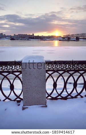 Embankment of the river Ob in Novosibirsk. Winter sunset at the TRANS-Siberian railway bridge