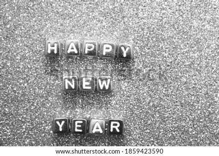 HAPPY NEW YEAR 2021 written with colorful cube.  Alphabet Beads on glitter  Background