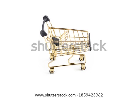 Studio lighting. children's shopping cart made of yellow metal with wheels. Close-up. On a white background, no isolation