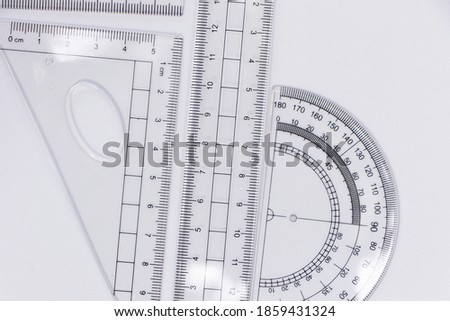 Rulers of different sizes and shapes especially white. Plastic school supplies to measure. School supplies objects