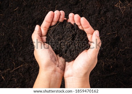 Top view of farmer woman hand holding compost fertile black soil background and copy space, Concept of Agriculture, gardening, Save World, Earth day and Hands ecology environment Royalty-Free Stock Photo #1859470162