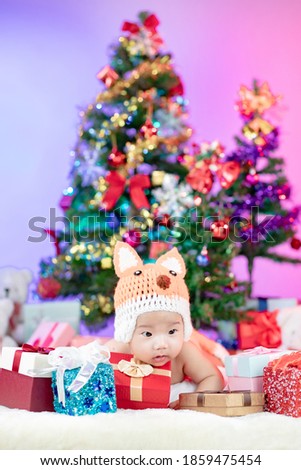 Happy new year Christmas tree with cute little baby wearing fox costume crochet knitted.