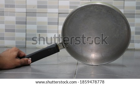 Stainless steel pan with black handle, take a picture of the top of the pan.