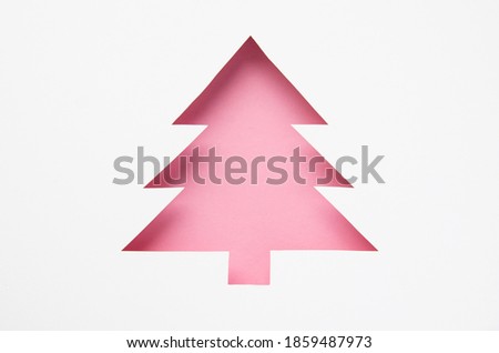 Greeting card with a Christmas tree cut out of paper. Silhouette of a fir tree. Happy new year. Merry christmas. 2021