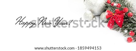 Christmas and New Year banner with toys and a red bow on a white background. Christmas composition on a white background with copy space. New Year's Holidays.