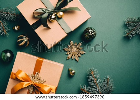 Christmas gifts and decoration on dark green background. Flat lay, top view. Vintage, retro style. Christmas holiday presents, New Year surprises.