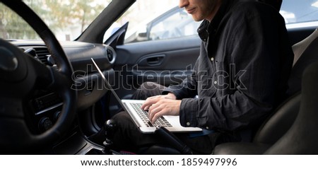 car mechanic doing auto diagnostic using computer, searching for check engine