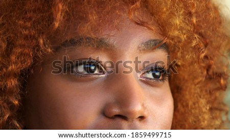 Brown eyes of young black woman close up. High quality photo