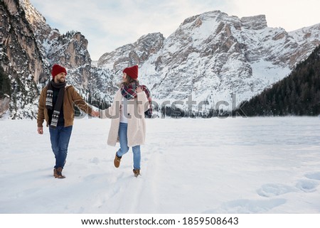 Boyfriend and girlfriend spend time together among the Dolomites in the Alps.