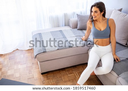 Shot of an attractive young woman taking a break while exercising at home. Shot of an attractive young woman relaxing after working out at home. Ready for workout 