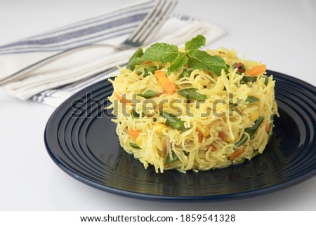 Semiya Upma or Vermicelli Uppuma or uppittu is a popular breakfast menu from south India. served in a bowl. selective focus Royalty-Free Stock Photo #1859541328