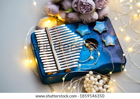 Kalimba on a gray background with decorations and lighting. Traditional musical instrument close-up.