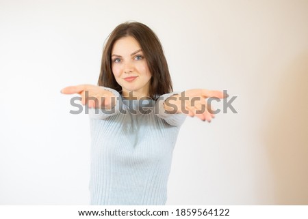 Young woman over isolated white background inviting to come with hands. Happy that you came