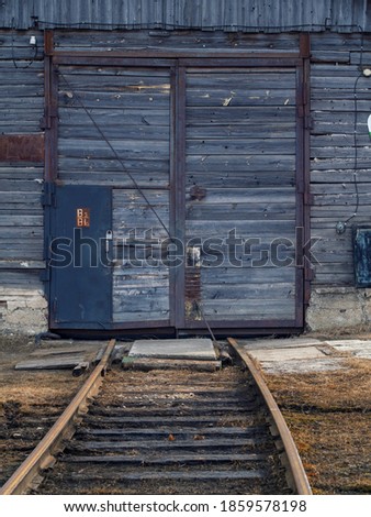 train tracks lead to a closed door